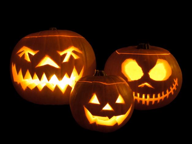 Three carved Jack-o'-lanterns. One looks like Jack Skellington from Nightmare Before Christmas.